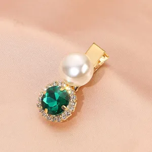 Exquisite vintage hair clip detail, green crystal and pearl design on gold-tone metal.