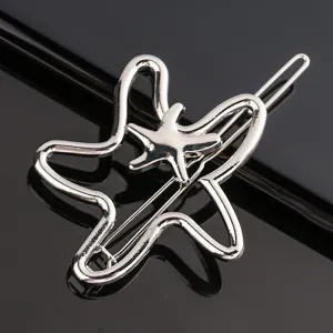 Close-up detail shot of a stylish silver metal star hair clip, shiny alloy side pin.
