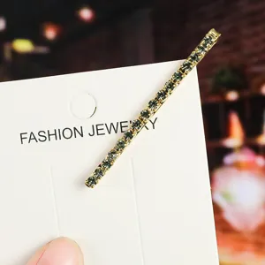 Detailed close-up of a sparkling rhinestone metal bobby pin on a white display card.