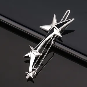 Detailed view of the metallic shooting star hair clip with sleek black enamel and shiny finish.