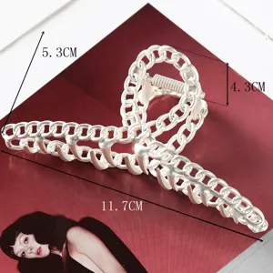 Large silver metallic chain hair claw clip for women, stylish vintage hair styling accessory.