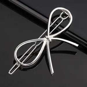Silver metal bow hair clip, minimalist alloy barrette, elegant hair styling accessory for women.