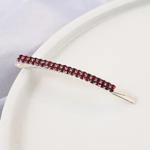 Close up of double row red rhinestone hair clip, elegant sparkling bobby pin for women.