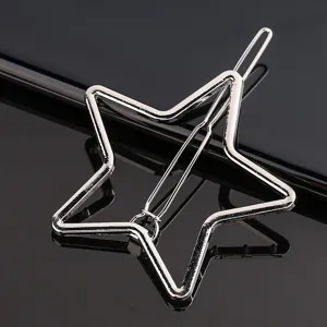 Close-up detail of a stylish silver star metal hair clip, showing the shiny alloy texture and clasp.