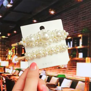Pearl hair clip detail shot, showing the exquisite clustered pearl design on card display.