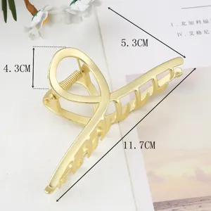 Detail view of the stylish gold metal hair claw clip showing precise product dimensions.