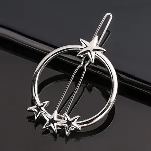 Silver metal hair clip with circle and star charms, trendy hair accessory detail view.