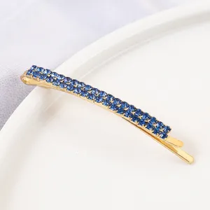 Elegant gold tone bobby pin featuring double rows of sparkling blue rhinestones for women.