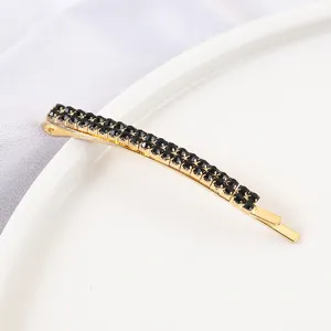 Gold hairpin with double rows of black rhinestones, elegant hair accessory for women.