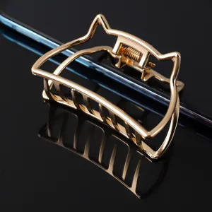 Gold metal hair claw clip with cute cat ear design, large alloy hair grab for elegant styling.