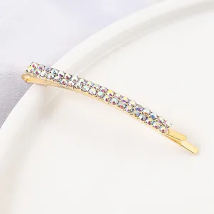 Detail view of golden double row rhinestone hair clip, sparkling crystal bobby pin for women bangs.