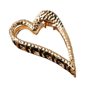 Gold metal hair claw clip, large heart shape hair accessory for women stylish daily wear.