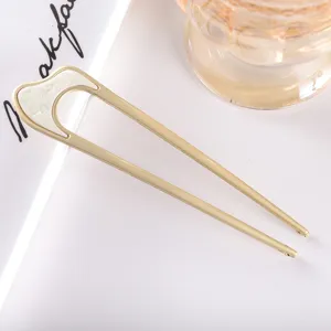 Minimalist metal U-shaped hair fork with white acetate inlay for elegant daily hair styling.