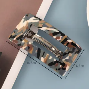 Detail van een rechthoekige acetaat haarspeld met afmetingen van 8,5x4,5 cm.