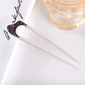 Modern minimalist U-shaped metal hair stick with abalone shell inlay for elegant buns.