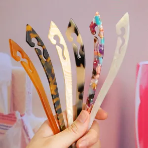 Detailed view of fashionable acetate hair sticks with hollow cloud patterns, set of 6.