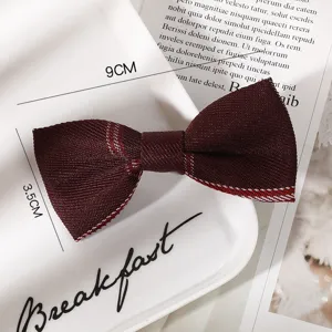 Burgundy plaid bow hair clip detail shot, featuring fabric material and school uniform JK style.