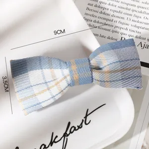 Closeup detail of blue plaid bow hair clip, Japanese JK style fabric hair accessory.