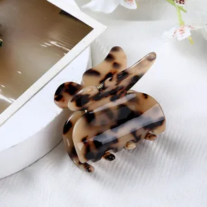 Acetate butterfly hair claw clip with stylish brown tortoiseshell pattern, elegant hair accessory.
