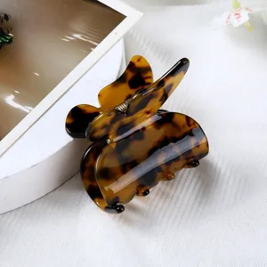 Detailed close-up of the elegant tortoiseshell acetate butterfly hair claw clip texture.