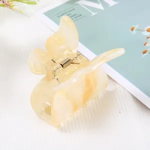 Elegant butterfly hair claw clip with marble texture, stylish acetate hair accessory.