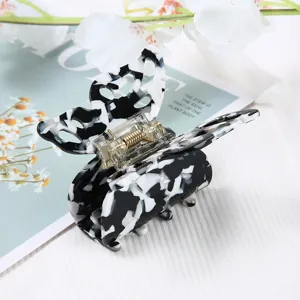 Detailed close-up view of the chic black and white marble butterfly hair claw clip.