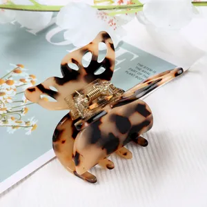 Close-up detail of the elegant tortoiseshell butterfly hair claw clip with metal spring.