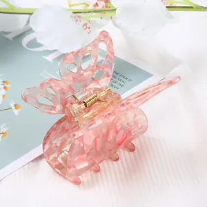 Pink marble butterfly hair claw clip detail shot, elegant acetate hair accessory for women.