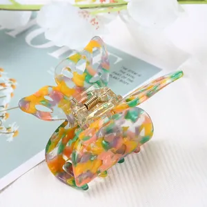 Beautiful butterfly hair claw clip with colorful marble pattern acetate, perfect detail shot.