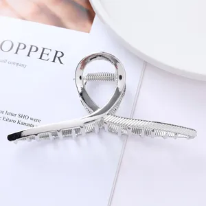 Detail shot of a sleek silver metal hair claw clip, elegant and durable hair styling accessory.