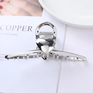 Silver metal hair claw clip with heart design elegant hair accessory for women daily styling.