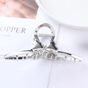 Silver metal hair claw clip for women, stylish bow heart hair accessory for daily styling.