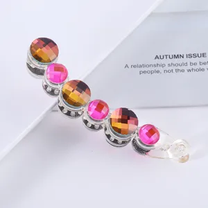 Transparent crystal banana hair clip with colorful rhinestones for elegant ponytail styling.