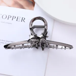 Geometric metal hair claw clip in dark gunmetal with cute star decor for chic daily hairstyles.