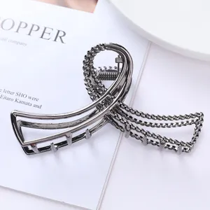 Geometric metal hair claw clip, dark grey hollow hair accessory for stylish women updos.