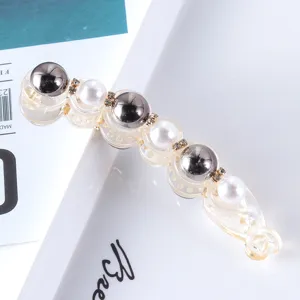 Pearl rhinestone banana hair clip detail view showing clear resin and elegant metallic spheres.