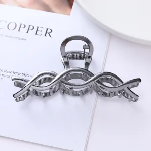 Detailed view of geometric metal hair claw clip, stylish gunmetal finish for daily elegant hair.