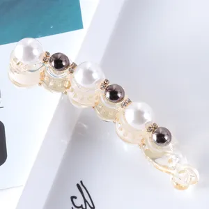 Detail shot of a stylish pearl rhinestone banana hair clip, minimalist hair accessories for women.