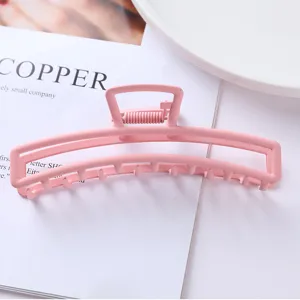 Minimalist pink metal hair claw clip, elegant matte finish big hair accessory for daily styling.