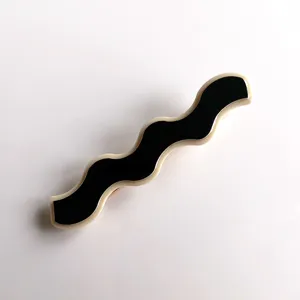 Closeup view of a stylish black and white wave acrylic hair clip detail design accessory.