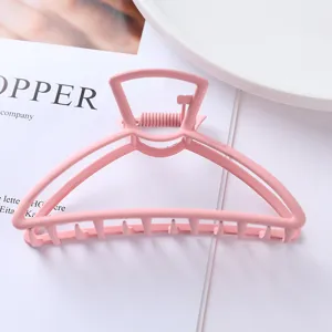 Pink metal hair claw clip for women, stylish geometric bunny head design for cute hairstyles.