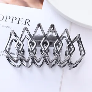Geometric metal hair claw clip detail shot, gunmetal lattice design for elegant daily hairstyles.