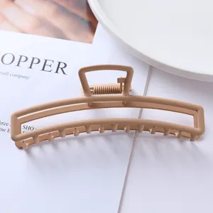 Matte metal hair claw clip, geometric hollow design, elegant hair accessory for women.