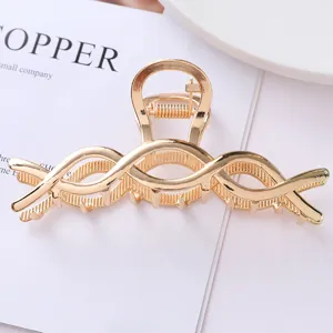 Gold metal hair claw clip with stylish hollow geometric design for secure ponytail styling.