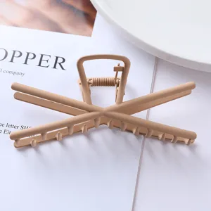Matte khaki geometric metal hair claw clip detail shot, elegant styling accessory for women.