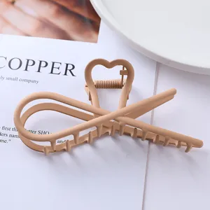 Minimalist geometric metal hair claw clip in elegant nude color for secure and stylish updos.