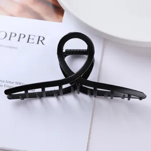 Close-up detail of the black geometric metal hair claw clip, stylish minimalist design for daily updos.