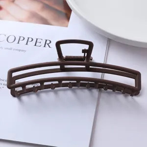 Matte brown metal hair claw clip, minimalist geometric hollow design for daily styling details.