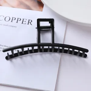 Geometric black metal hair claw clip for women, elegant minimalist design for secure daily hold.