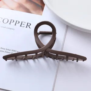 Brown matte geometric hair claw clip detail shot, perfect for secure daily ponytails and buns.